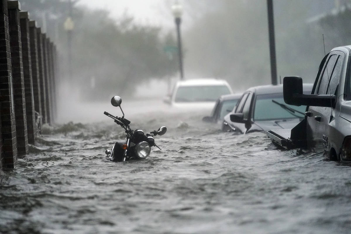 Flood waters move on the street, Wednesday, Sept. 16, 2020, in Pensacola, Fla. Hurricane Sally ...