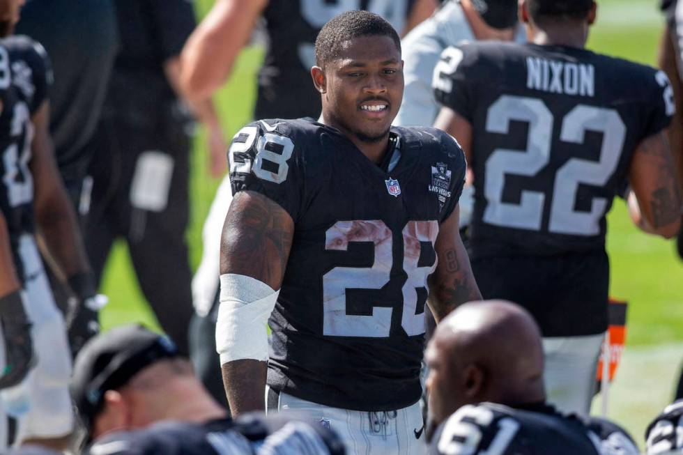 Las Vegas Raiders running back Josh Jacobs (28) smiles as he walks toward the bench in the 4th ...
