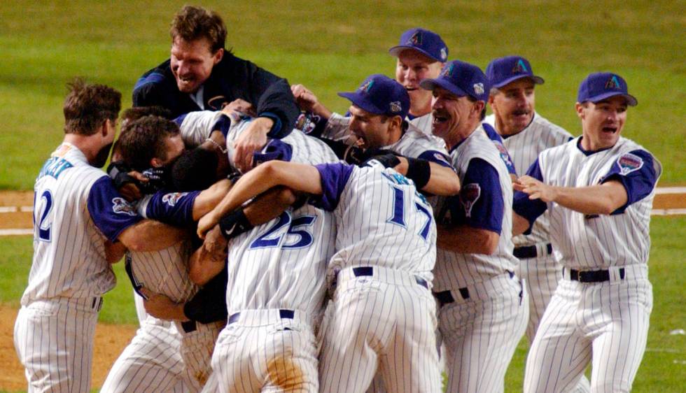 FILE - In this Nov. 4, 2001, file photo, the Arizona Diamondbacks celebrate their ninth-inning ...