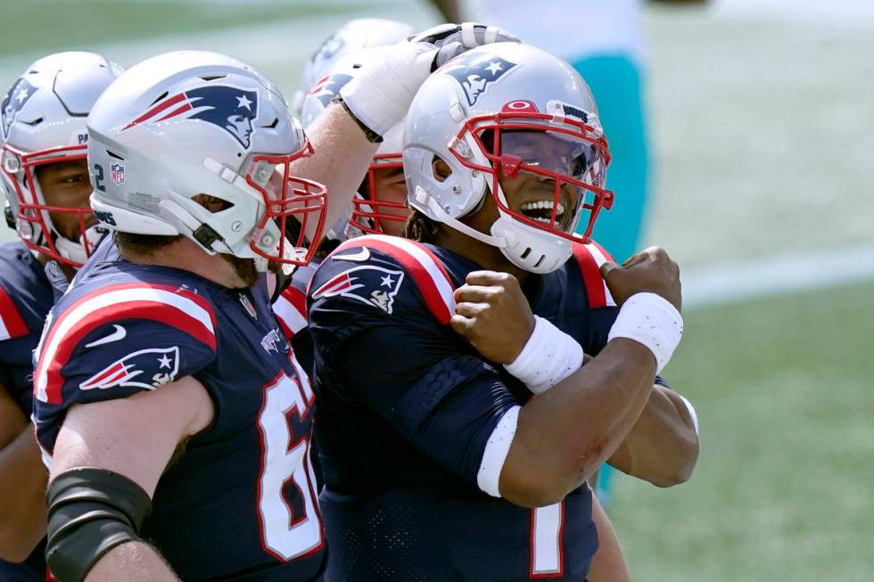 New England Patriots quarterback Cam Newton (1) celebrates his rushing touchdown against the Mi ...