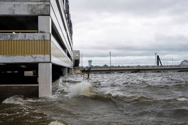 Storm surge from Hurricane Sally overtakes the outside parking lot and the first floor of the P ...