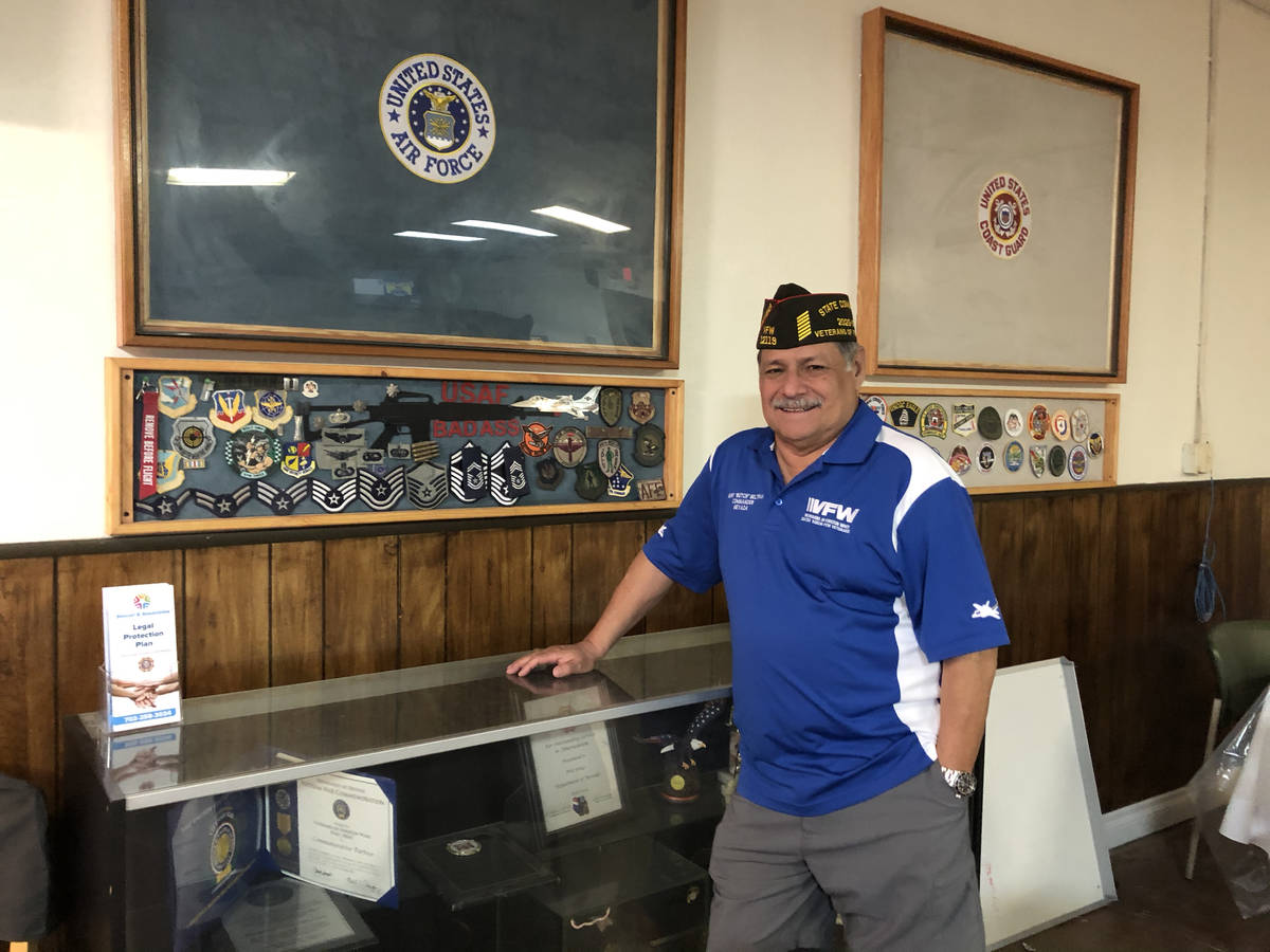 Henry "Butch" Beltran, 70, Nevada State VFW Commander posing in front of an Air Force display c ...