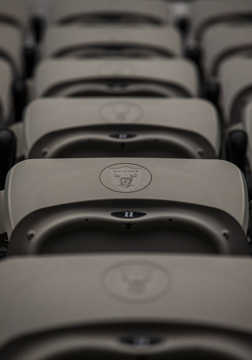 Each seat is marked with the Las Vegas Raiders logo at Allegiant Stadium on Friday, Sept. 18, 2 ...