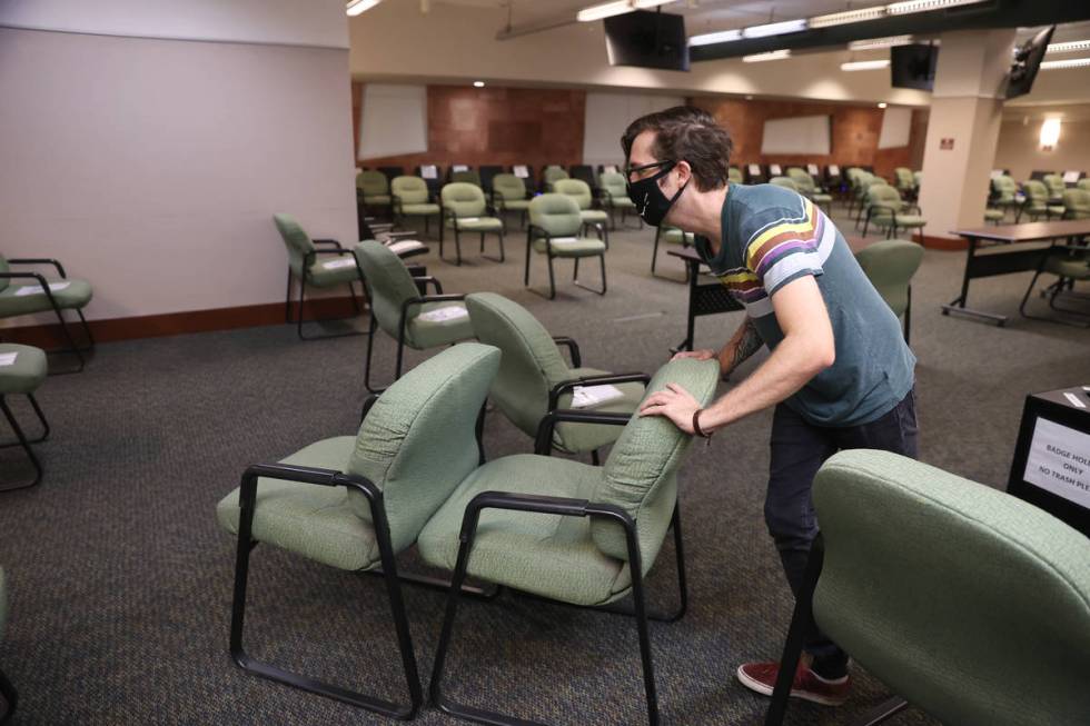 Jury Clerk Salvatore Savini removes extra chairs from the updated Regional Justice Center jury ...