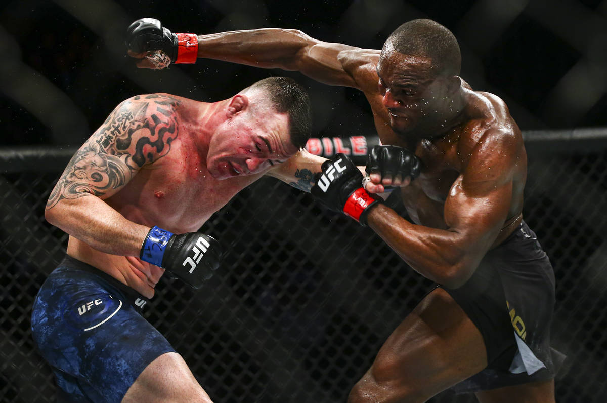 Kamaru Usman, right, fights Colby Covington during their welterweight title boutÊin UFC 24 ...