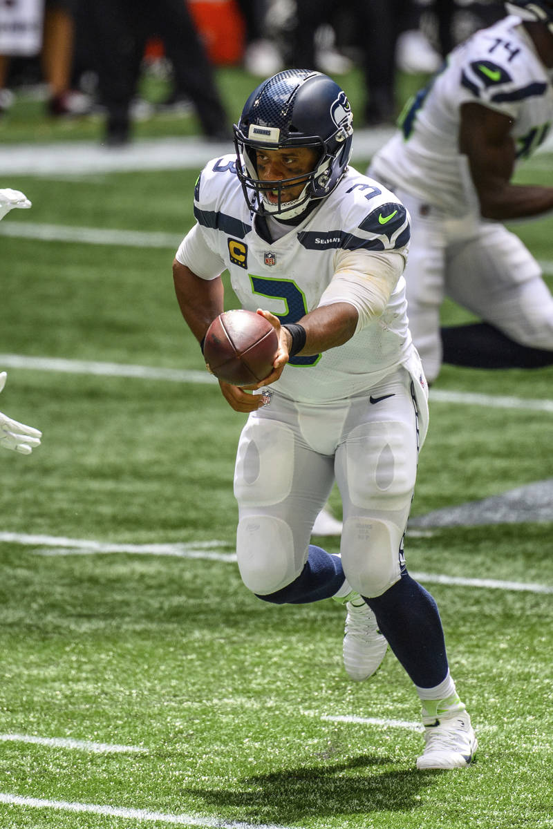 Seattle Seahawks quarterback Russell Wilson (3) works against the Atlanta Falcons during the fi ...
