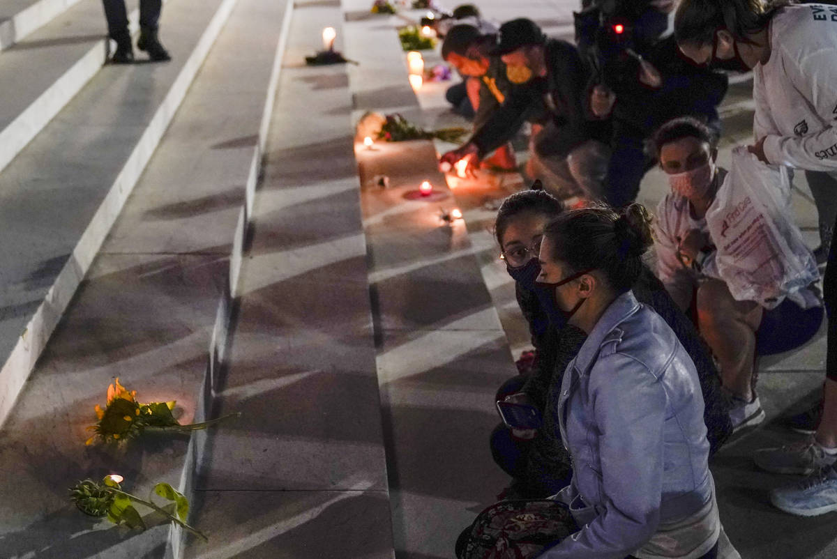 People lay flowers and light candies outside the Supreme Court Friday, Sept. 18, 2020, in Washi ...