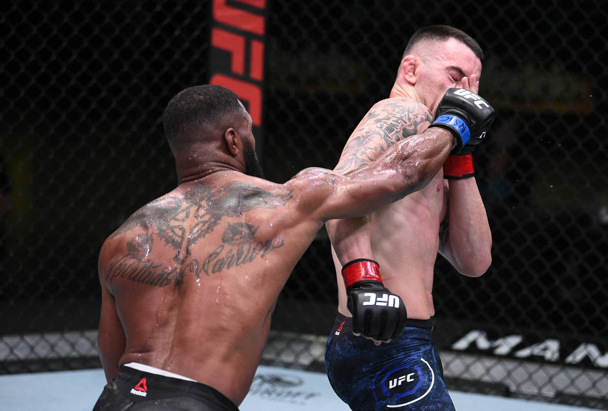 Tyron Woodley, left, punches Colby Covington in their welterweight bout during the UFC Fight Ni ...