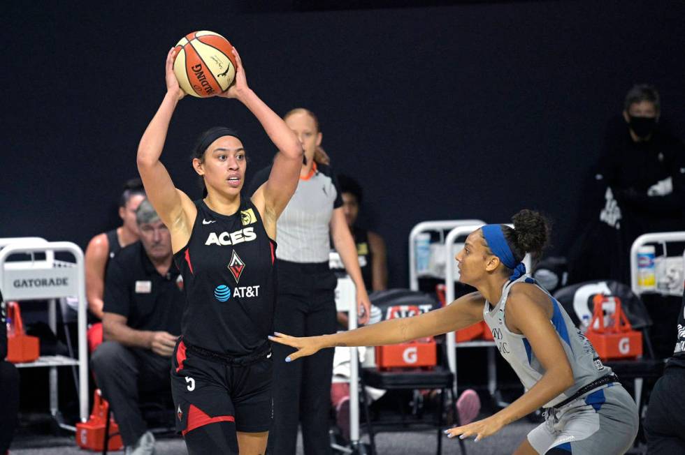 Las Vegas Aces forward Dearica Hamby (5) looks to pass the ball in front of Minnesota Lynx forw ...