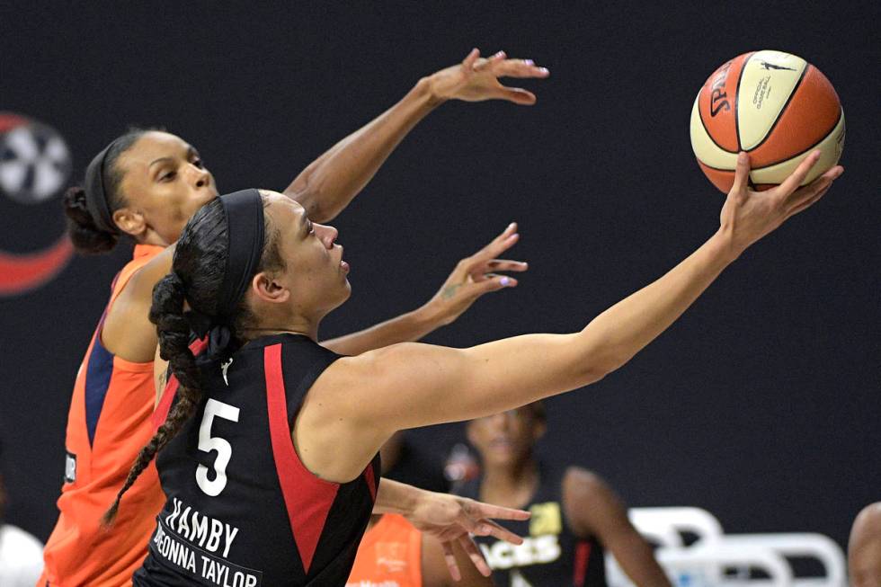 Las Vegas Aces forward Dearica Hamby (5) goes up to shoot in front of Connecticut Sun forward D ...