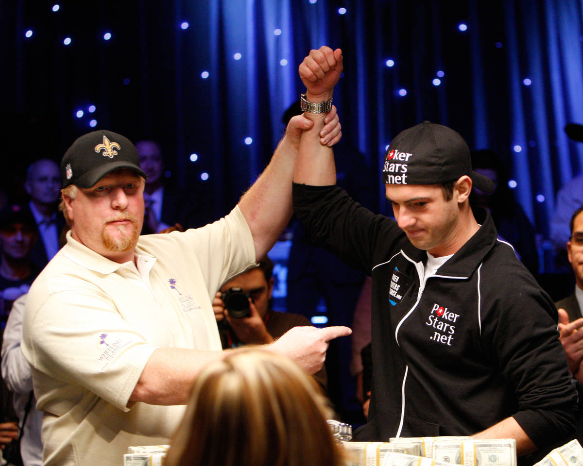 Darvin Moon raises Joseph Cada's hand in victory after winning the 2009 World Series of Poker m ...