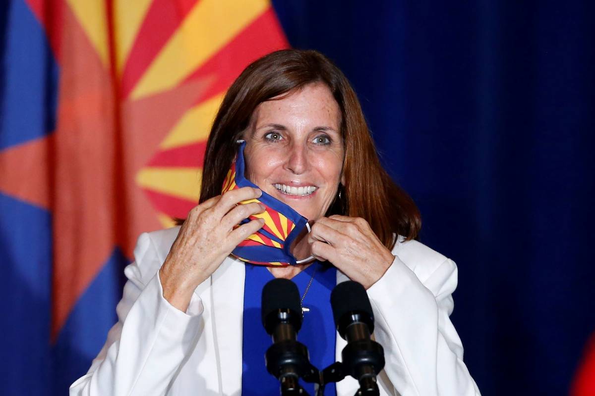 Sen. Martha McSally, R-Ariz., smiles as she removes her face covering to speak prior to Vice Pr ...