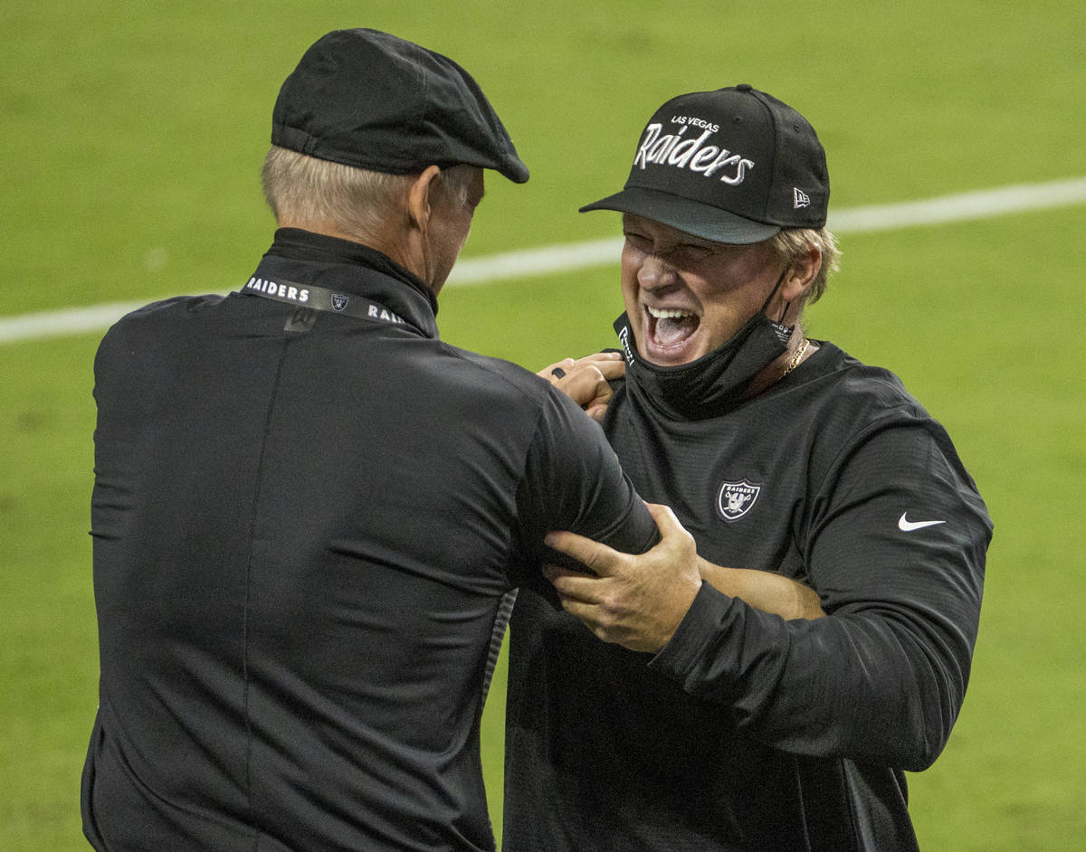 Las Vegas Raiders general Manager Mike Mayock, left, celebrates a win with head coach Jon Grude ...