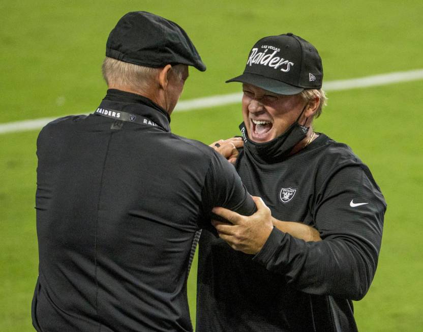 Las Vegas Raiders general Manager Mike Mayock, left, celebrates a win with head coach Jon Grude ...