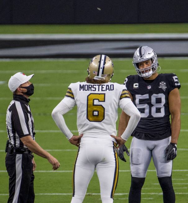 Las Vegas Raiders linebacker Kyle Wilber (58, right) looks up to the coin toss with New Orleans ...