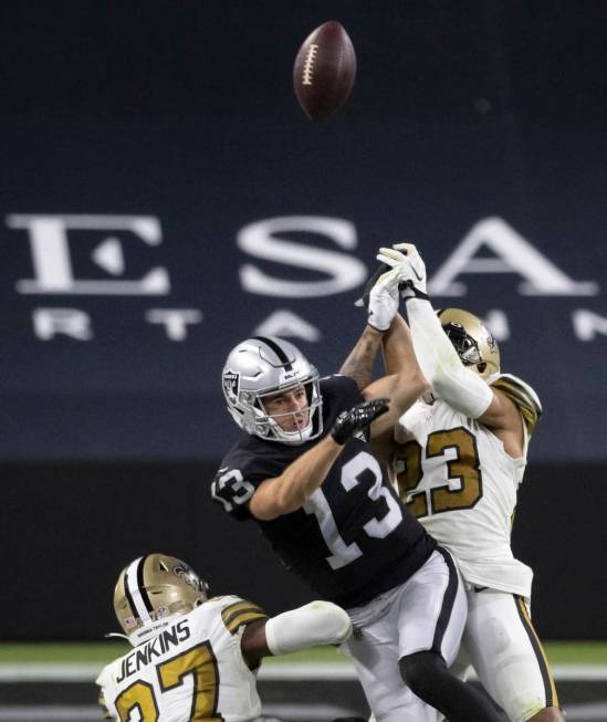 Las Vegas Raiders wide receiver Hunter Renfrow (13) has a pass broken up by New Orleans Saints ...