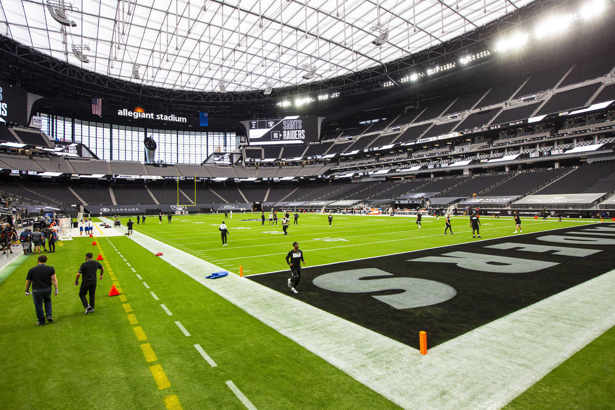 Las Vegas Raiders players warm up before their home opening NFL football game at Allegiant Stad ...