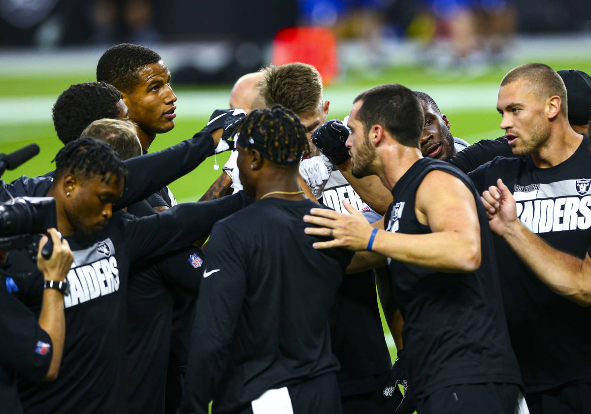 Las Vegas Raiders players gather before their home opening NFL football game against the N ...