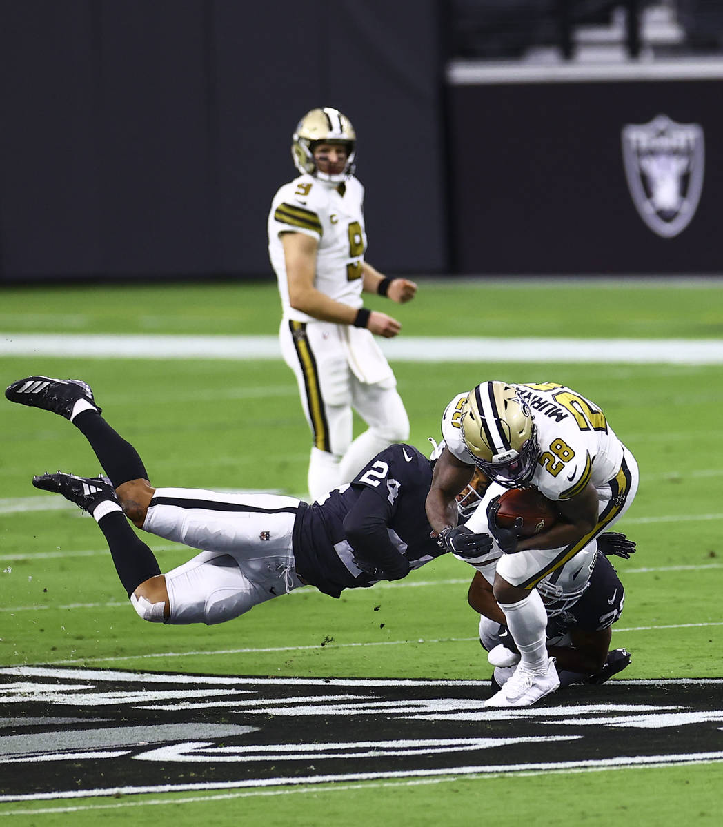Las Vegas Raiders safety Johnathan Abram (24) tackles New Orleans Saints running back Latavius ...