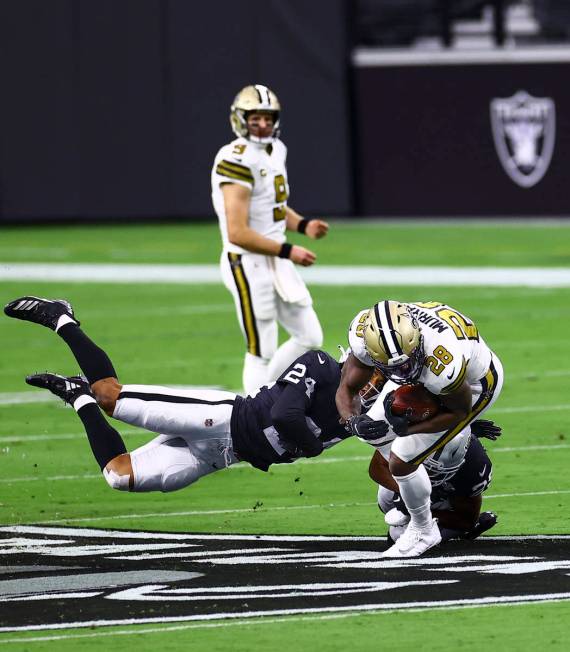 Las Vegas Raiders safety Johnathan Abram (24) tackles New Orleans Saints running back Latavius ...