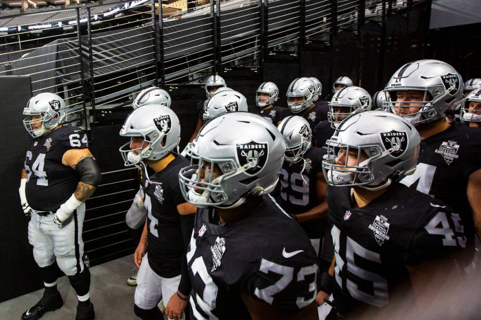 Las Vegas Raiders players get ready to take the field for the start of their home opening NFL g ...