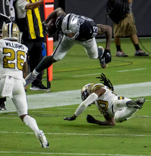 Las Vegas Raiders tight end Darren Waller (83) holds onto a catch after being taken off his fee ...