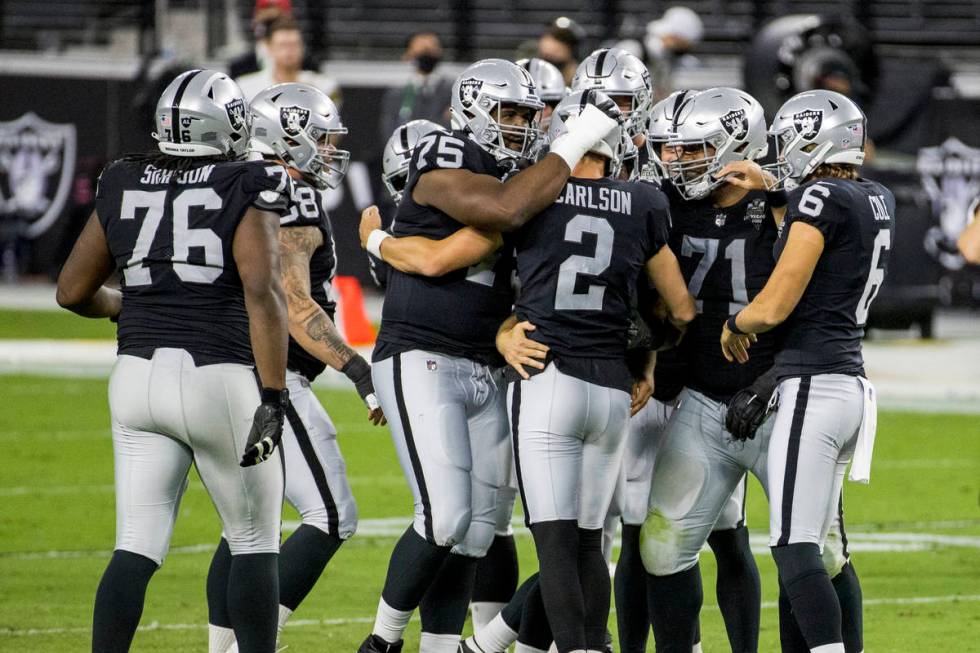 Las Vegas Raiders kicker Daniel Carlson (2) is congratulated by teammates on his late-game fiel ...