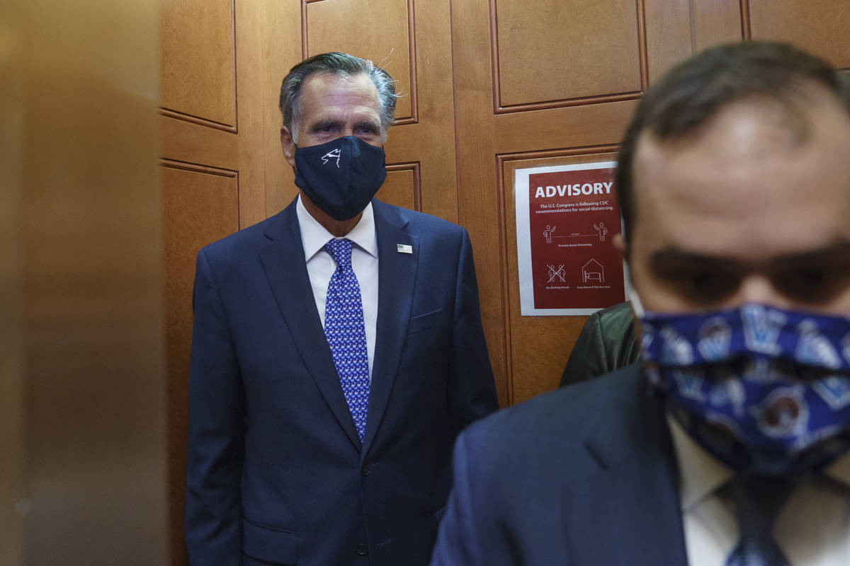 Sen. Mitt Romney, R-Utah, leaves the Senate Chamber after a procedural vote, at the Capitol in ...