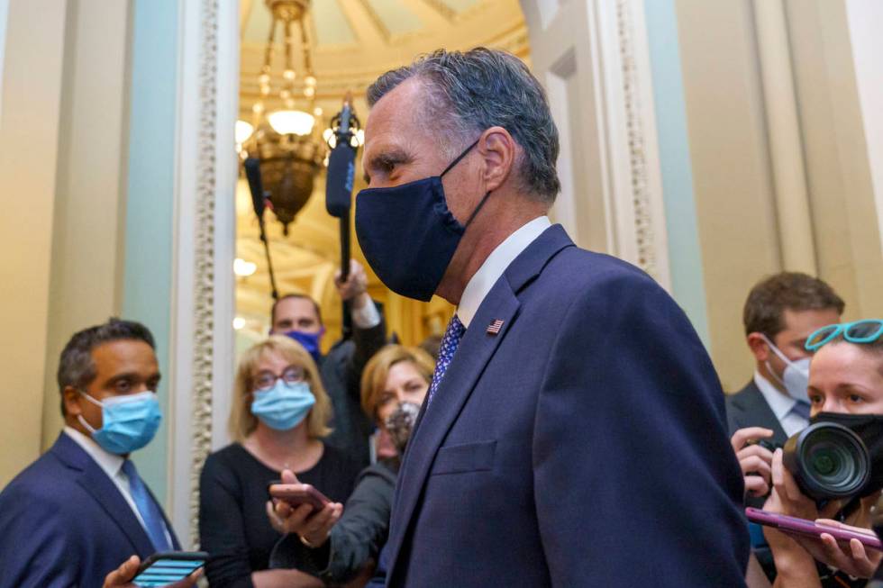 Sen. Mitt Romney, R-Utah, leaves the Senate Chamber following a vote, at the Capitol in Washing ...