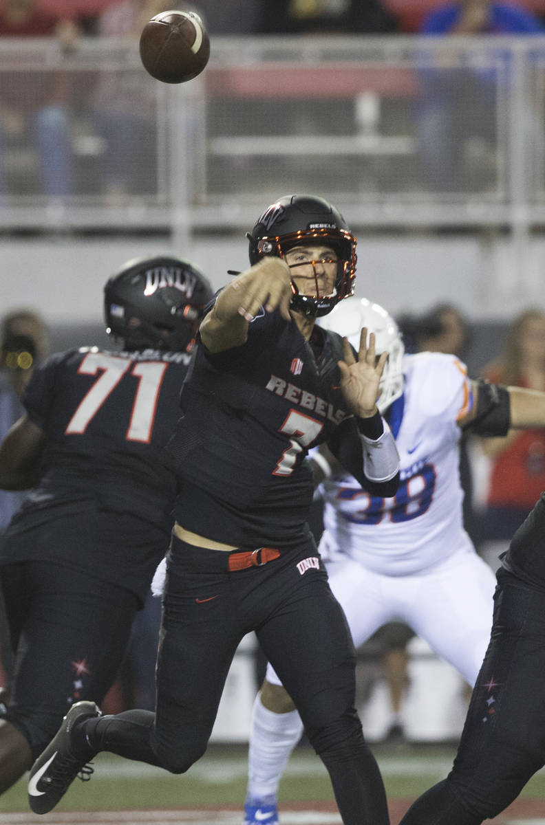 UNLV Rebels quarterback Kenyon Oblad (7) makes a sideline pass before the rush from Boise State ...