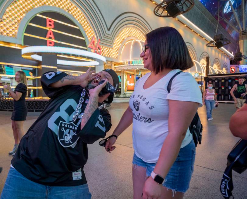 Raiders fans from Rio Rancho, New Mexico, Christopher Rodarte, left, and Juliet Cardozo, celebr ...