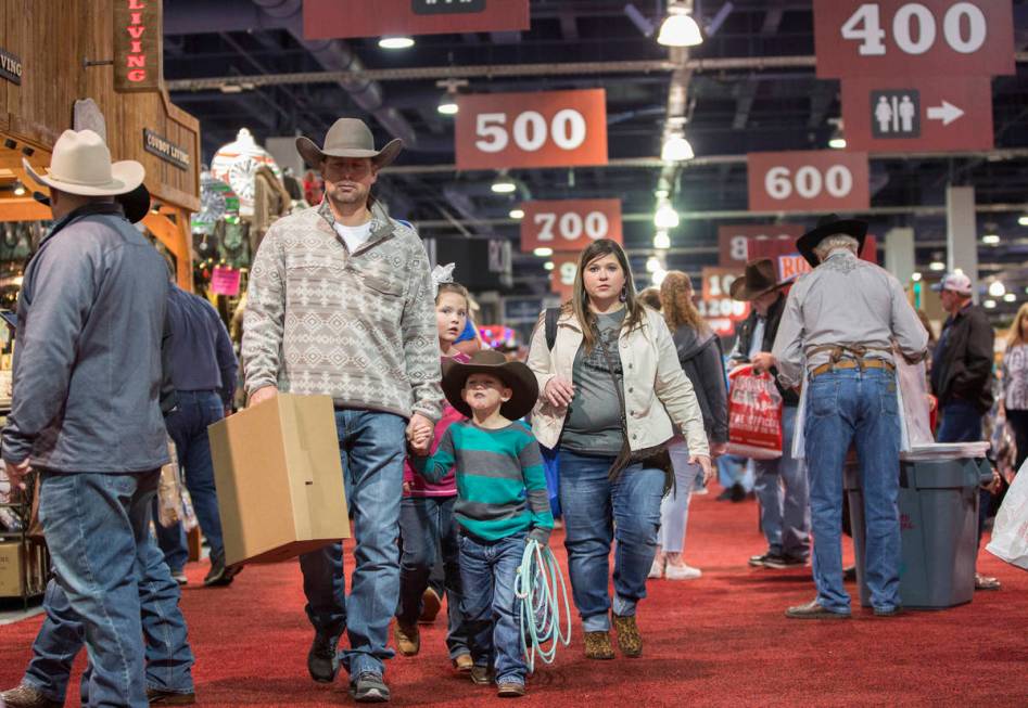 Shoppers walk the South Halls during Cowboy Christmas at the Las Vegas Convention Center on Thu ...