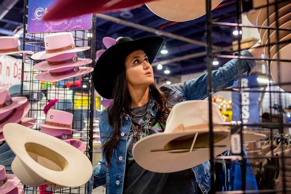 Kylee Hamilton of Texas, marketing for Charlie 1 Horse, organizes felt hats available for purch ...