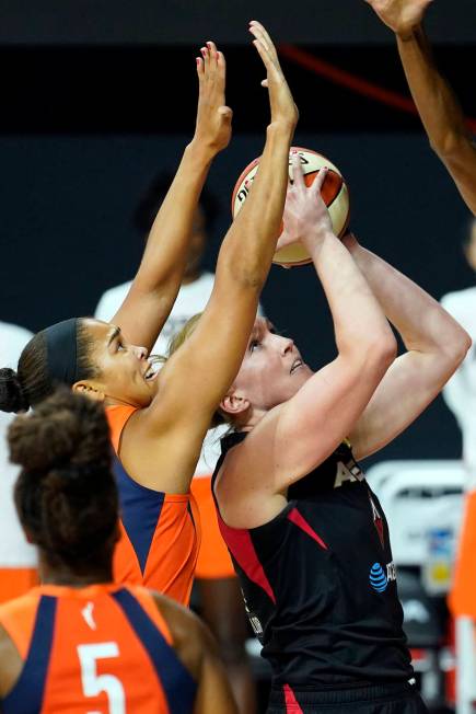 Las Vegas Aces center Carolyn Swords (4) shoots in front of Connecticut Sun center Brionna Jone ...