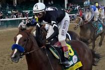 Jockey John Velazquez rides Authentic to win the 146th running of the Kentucky Derby at Churchi ...