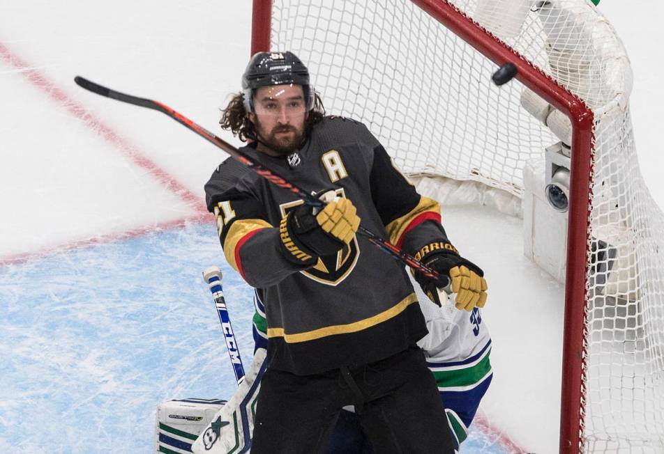 Vegas Golden Knights' Mark Stone (61) tries for the rebound next to Vancouver Canucks goaltende ...