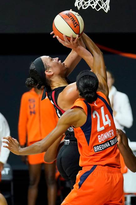 Las Vegas Aces forward Dearica Hamby (5) shoots over Connecticut Sun forward DeWanna Bonner (24 ...