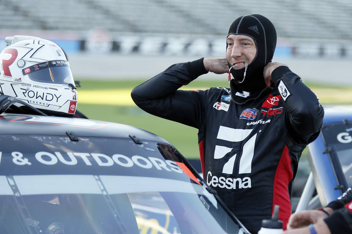 Kyle Busch prepares himself to enter the truck prior the NASCAR Trucks auto race at Texas Motor ...