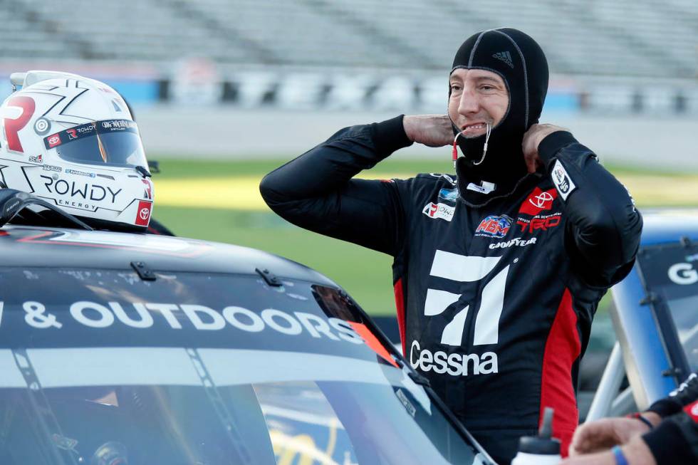 Kyle Busch prepares himself to enter the truck prior the NASCAR Trucks auto race at Texas Motor ...