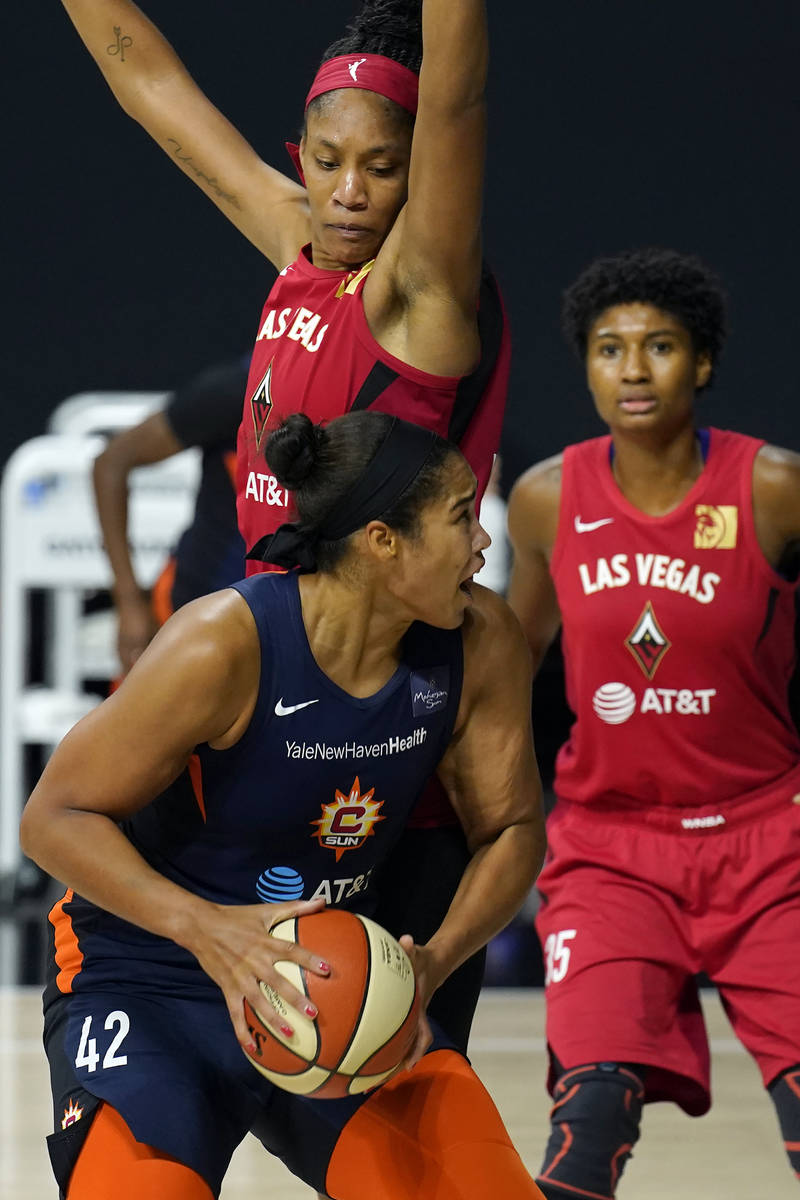 Connecticut Sun center Brionna Jones (42) goes up against Las Vegas Aces center A'ja Wilson (22 ...