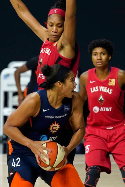 Connecticut Sun center Brionna Jones (42) goes up against Las Vegas Aces center A'ja Wilson (22 ...