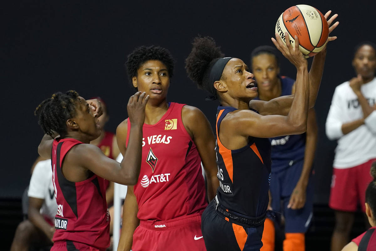 Connecticut Sun guard Jasmine Thomas (5) shoots after driving past Las Vegas Aces guard Daniell ...