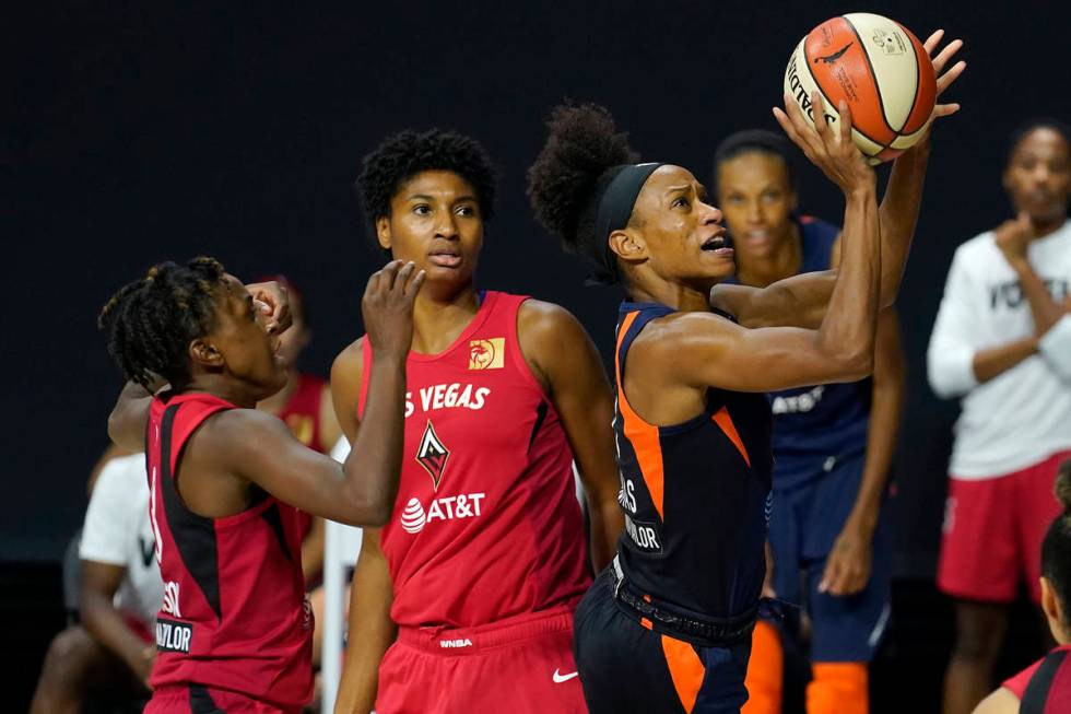 Connecticut Sun guard Jasmine Thomas (5) shoots after driving past Las Vegas Aces guard Daniell ...