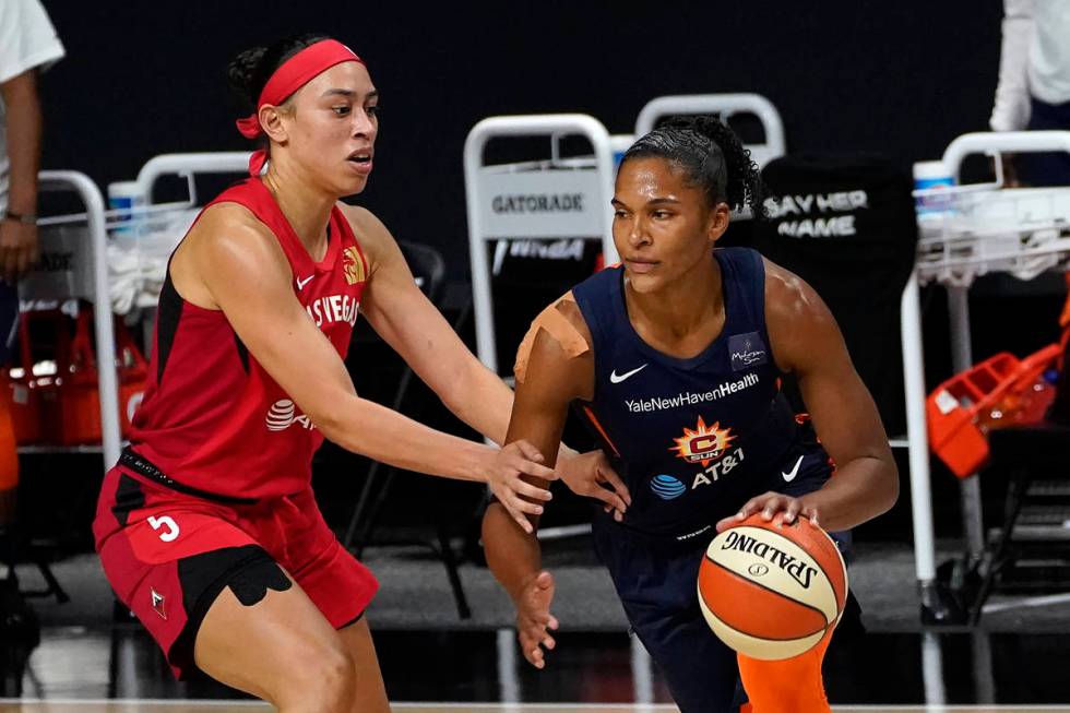 Connecticut Sun forward Alyssa Thomas (25) drives around Las Vegas Aces forward Dearica Hamby ( ...