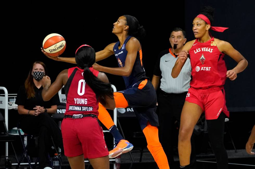 Connecticut Sun forward DeWanna Bonner (24) goes for a layup between Las Vegas Aces guard Jacki ...