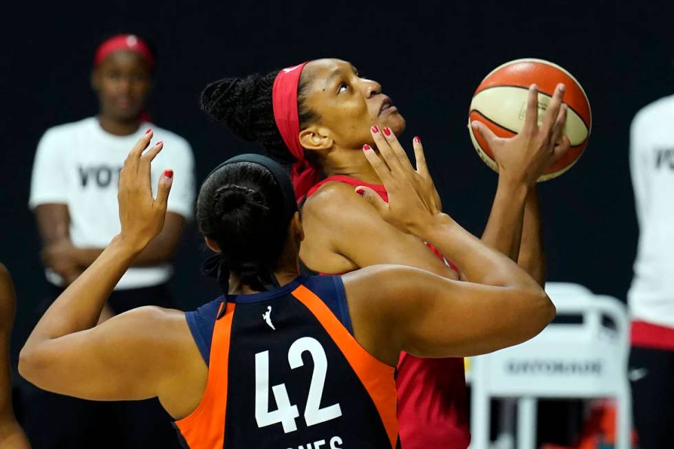 Las Vegas Aces center A'ja Wilson (22) goes up for a basket in front of Connecticut Sun center ...