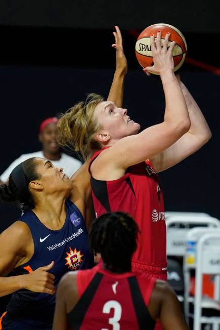 Las Vegas Aces center Carolyn Swords (4) shoots over Connecticut Sun center Brionna Jones (42) ...