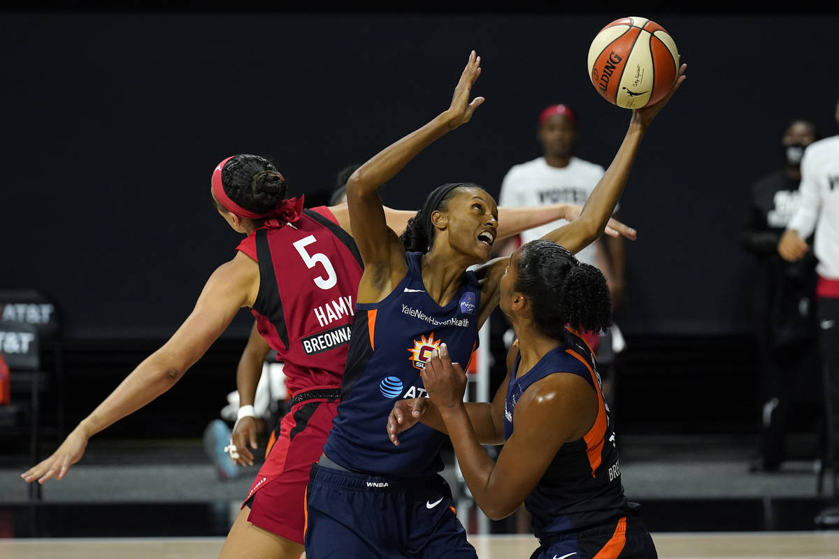 Connecticut Sun forward DeWanna Bonner (24) grabs a rebound away from Las Vegas Aces forward De ...