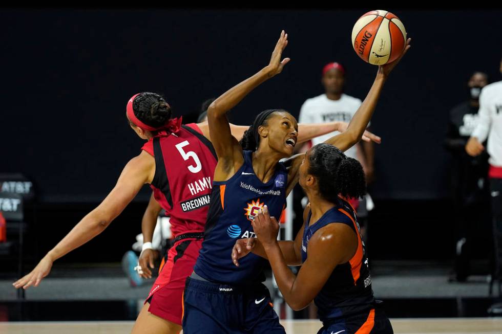 Connecticut Sun forward DeWanna Bonner (24) grabs a rebound away from Las Vegas Aces forward De ...