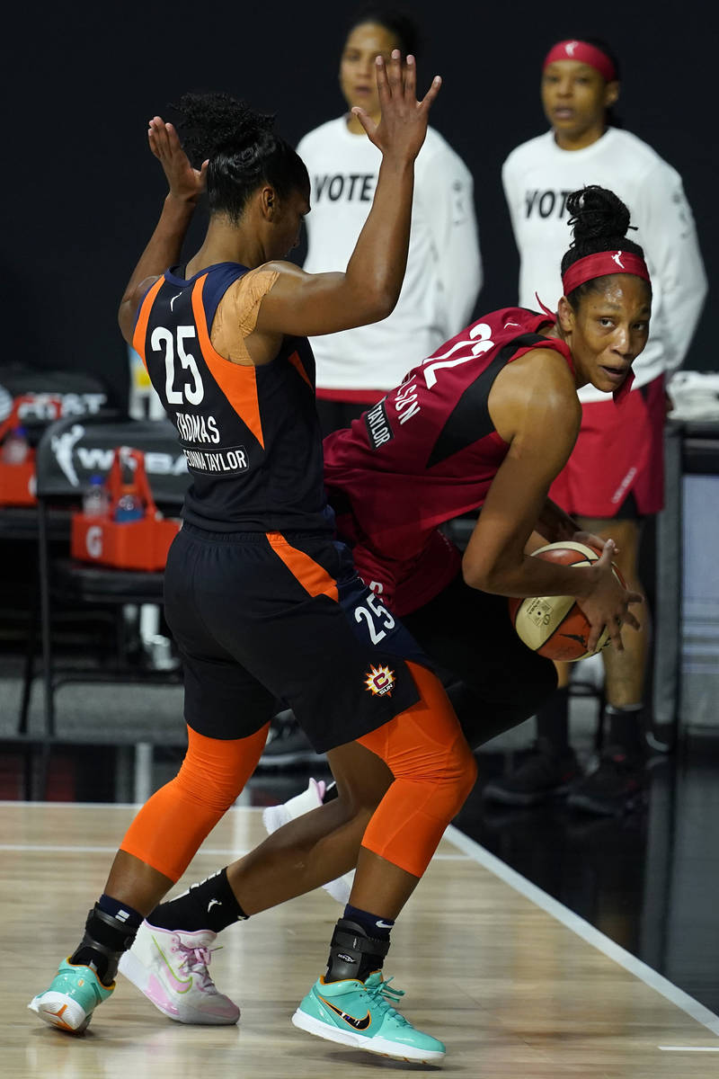 Connecticut Sun forward Alyssa Thomas (25) forces Las Vegas Aces center A'ja Wilson (22) out of ...